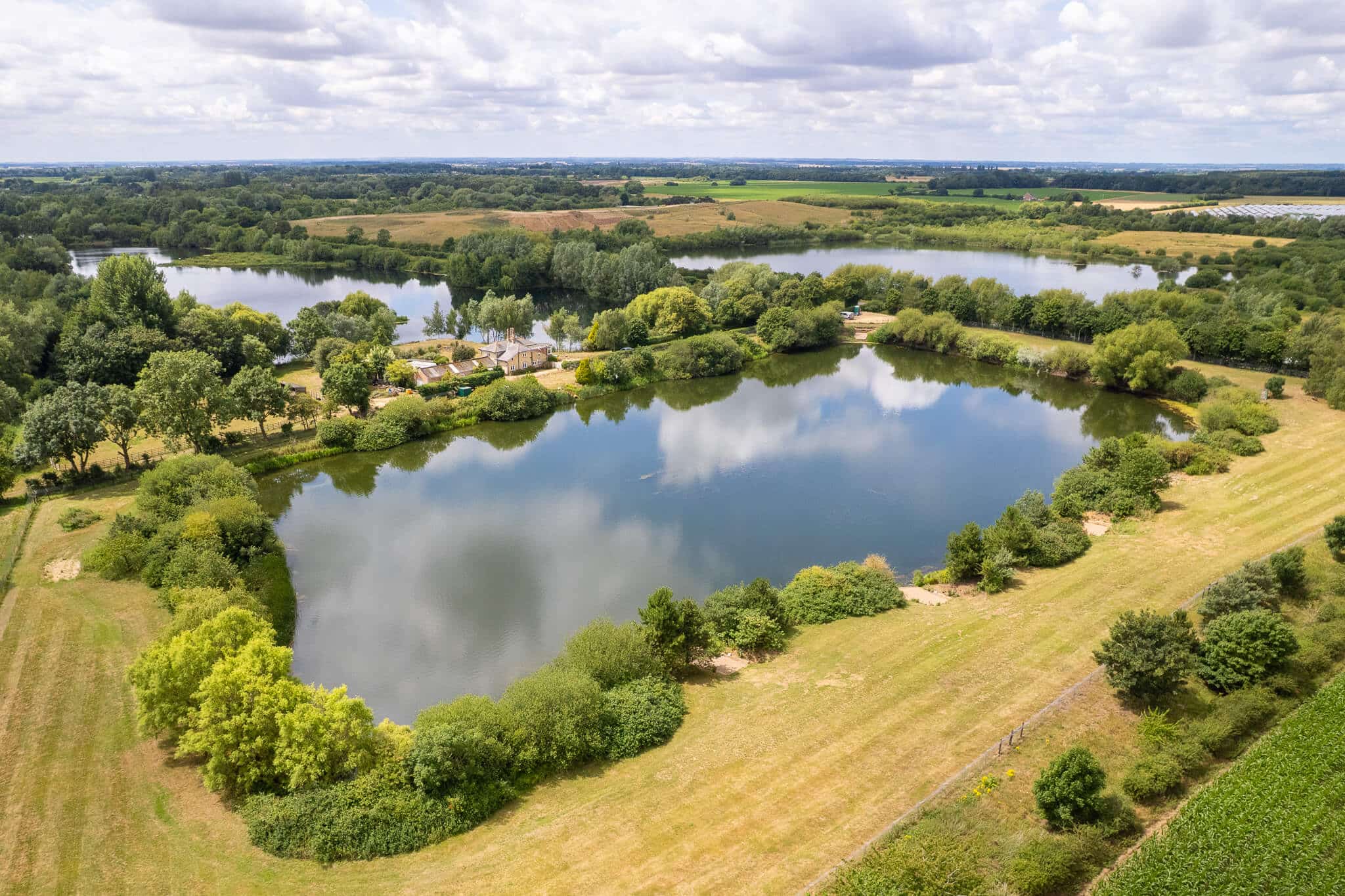 Riverslea Farm Lake carp fishery — panoramic view of swims, water, and reed margins